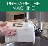 Person preparing the BISSELL® Big Green® Machine by filling tank with water
